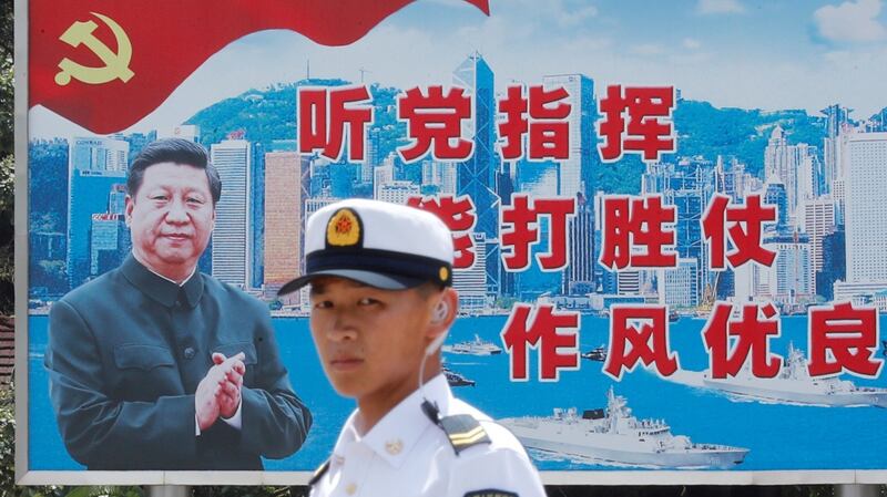 A People’s Liberation Army sailor passes by a backdrop featuring Chinese president Xi Jinping at Stonecutters Island naval base in Hong Kong in June. Photograph: Tyrone Siu/Reuters