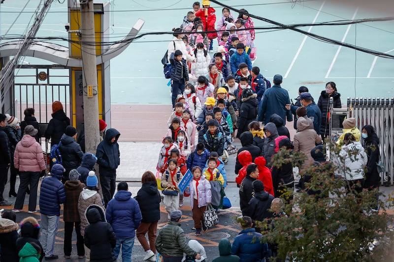 Pupils leave a primary school at the end of the day in Beijing. Photograph: Mark R Cristiano/EPA-EFE