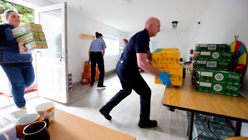 Gardaí from Boyle, Co Roscommon, help unload  food donated by local businesses. Photograph: Brian Farrell/The Irish Times