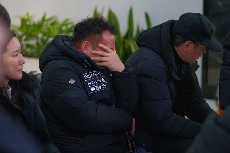 Distraught family members at Muan International Airport in South Korea after the Jeju Air passenger jet crash on Sunday. Photograph: Chang W Lee/New York Times
                      