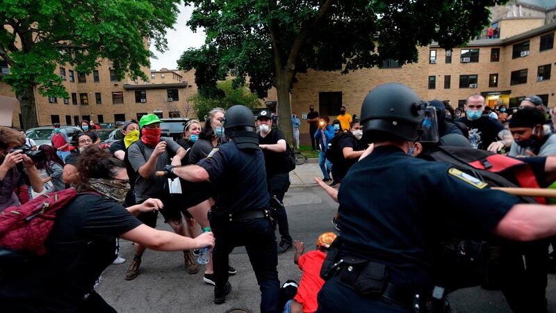 Police use batons as they clash with protesters outside the District Four Police station during a Black Lives Matter protest against police brutality and racism in the US in Boston, Massachusetts. Photograph: AFP via Getty Images