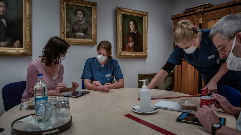 Dr Camilla Roth helps a volunteer fill out a questionnaire in a coronavirus study at a nursing home in Munich. Photograph: Laetitia Vancon/New York Times