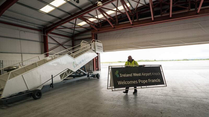 Donal Healy, marketing manager at Ireland West Airport Knock, carrying signs in preparation for the visit of Pope Francis. Photograph: Keith Heneghan