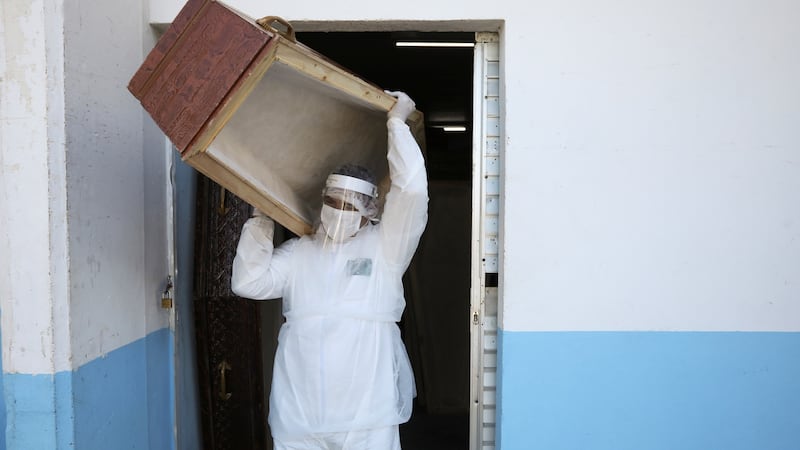 A worker of the Funeral SOS of the city of Manaus, wearing protective clothing, carries a coffin amid the coronavirus disease  outbreak, in  Brazil on Wednesday. Photograph: Bruno Kelly/Reuters