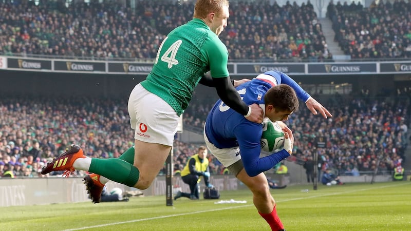 Thomas Ramos gathers the ball under pressure from Keith Earls. Photo: Paul Faith/Getty Images