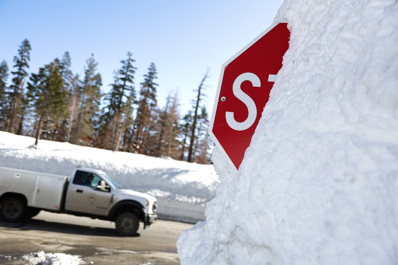 A truck passes by a stop sign buried in snow on March 3rd in Twin Bridges, California. Photograph: Justin Sullivan/Getty Images