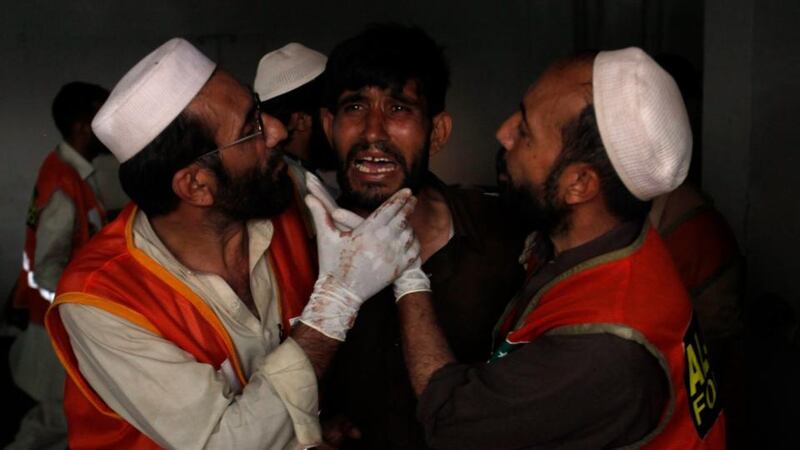 A man cries over the death of his brother, who was killed in a bomb blast, at a hospital in Peshawar. Photograph: Fayaz Aziz/Reuters