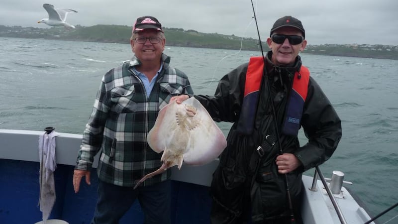 John Devlin (right) with a fine thornback ray caught off Roches Point on a recent Irish Times outing to Cobh, Co Cork. He is with charter skipper Donal Geary (087-277 6566)