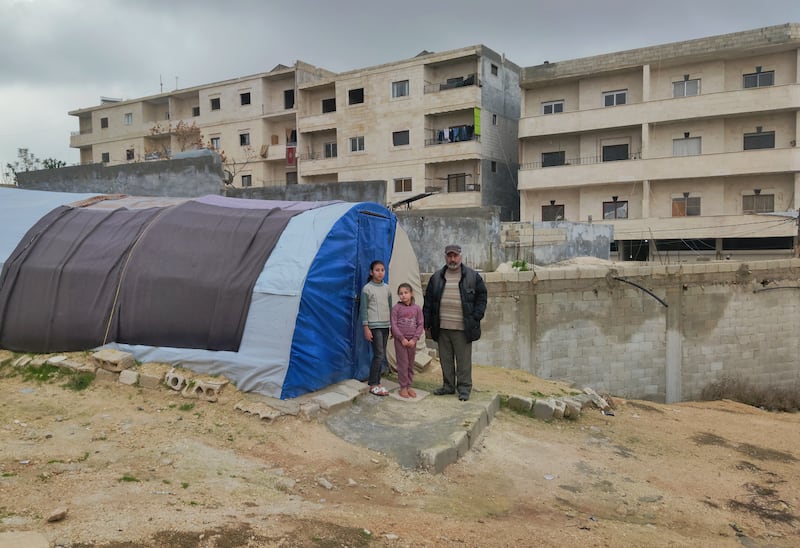 Rafiq with his daughters Leila (10) and Yasmine (7) outside the tent they’ve lived in since the earthquakes