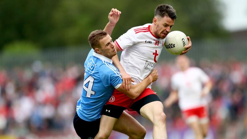 Tyrone’s Mattie Donnelly holds off Paul Mannion of Dublin during the All-Ireland quarter-final game at Healy Park in Omagh. Photograph:    James Crombie/Inpho