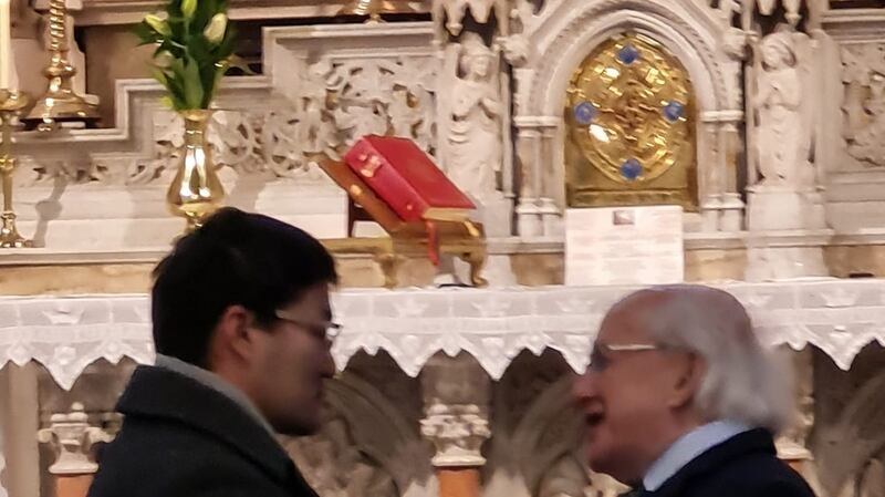 President Michael D. Higgins embraces Ulambayar Surenkho following a Mass in memory of his wife  Urantsetseg Tserendorj at St Kevin’s Church on Dublin’s Harrington Street