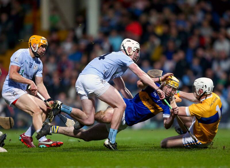 Patrickswell’s Jason Gillane saves at the feet of Na Piarsaigh’s Will Henn. Photograph: Ken Sutton/Inpho 