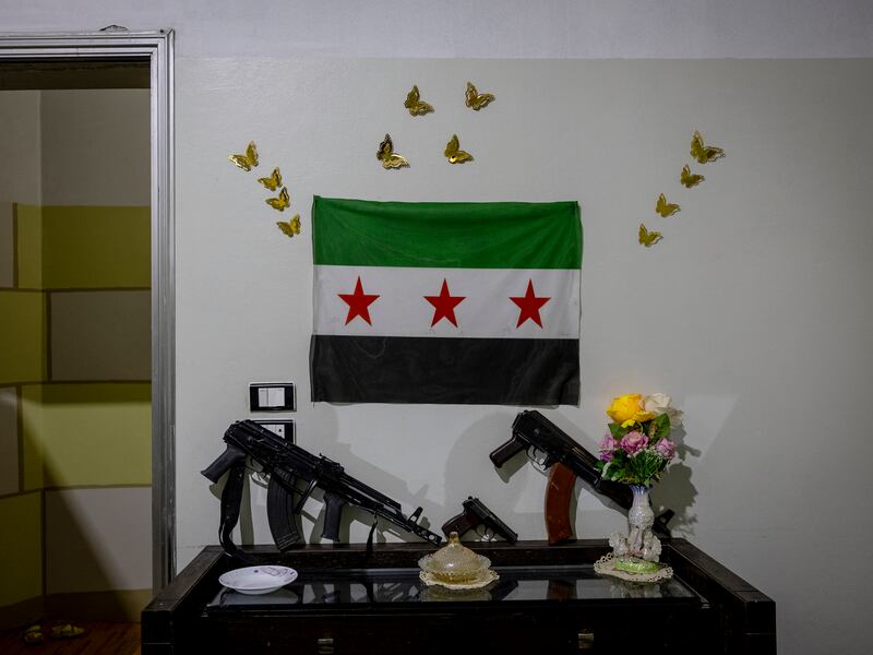 Two AK-47s, a handgun and a Syrian independence flag displayed at the home of Muhammad Ali Basha in Idlib. Photograph: Ivor Prickett/New York Times