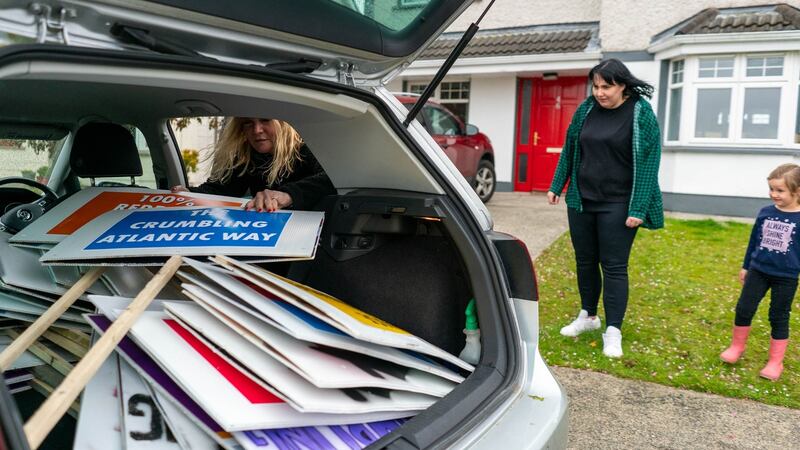 Jamie Lee Donnelly and her daughter Katie wait at their home in Ballina, Co Mayo, which is affected by pyrite and will have to be demolished while fellow protester Clair O’Connor, Lacken, Co Mayo sorts placards in the back of her car. Photograph : Keith Heneghan