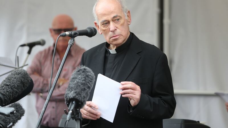 Fr Kevin Mullan reading a poem   during the commemoration ceremony for victims of the Omagh bombing. Photograph: Niall Carson/PA