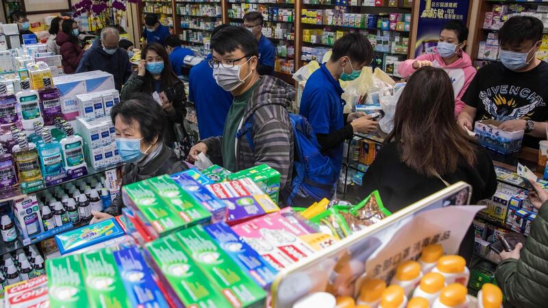 People leaving a pharmacy in Hong Kong after buying surgical masks as a preventative measure against the virus outbreak. Photograph: AFP via Getty