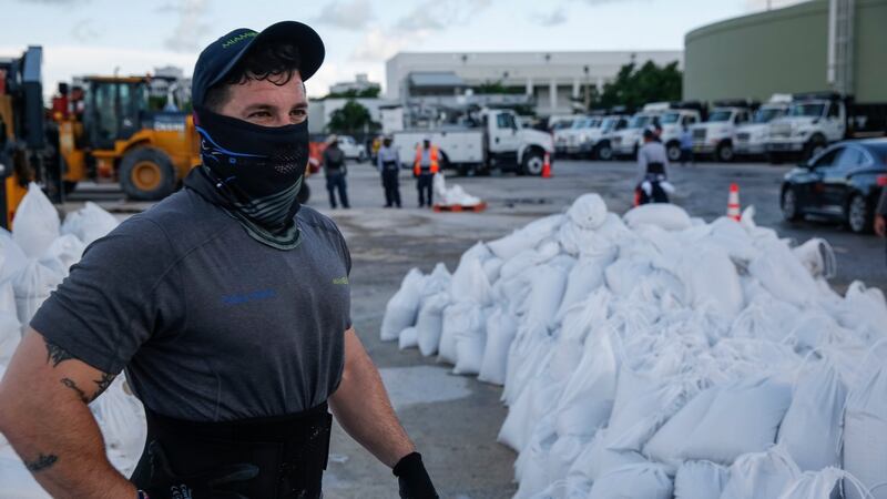 Workers fill sandbags and help load them into residents’ cars in Miami Beach, Florida, on Saturday  in preparation for hurricane Dorian. Photograph: Getty images