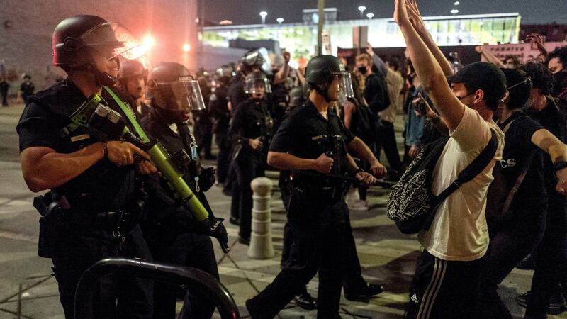 Protesters confront police officers during a protest over the death of George Floyd. Photograph: AP