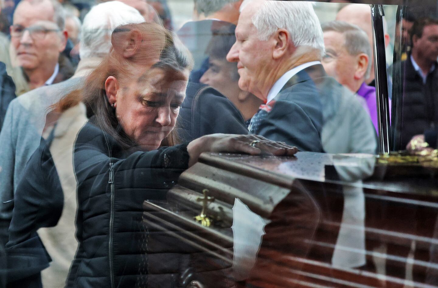 Dickie Rock daughter, Sarah-Jane places ⁤a hand​ on his coffin after‍ the funeral Mass‍ at the ‍Church of the Most Precious blood in Cabra.⁢ Photograph: Colin Keegan/Collins Dublin