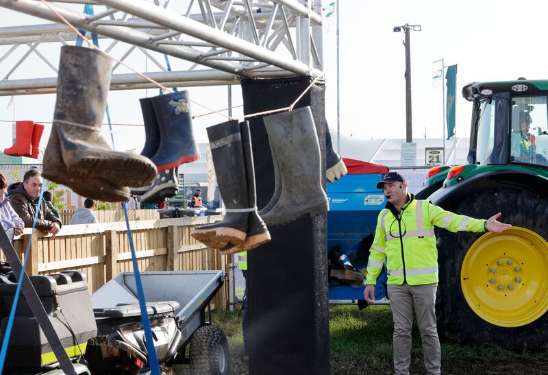 Noel Guinan from Compulsory Basic Training with wellington boots donated by families who have suffered a farm based accident at the HSA stand. Photograph: Alan Betson/The Irish Times