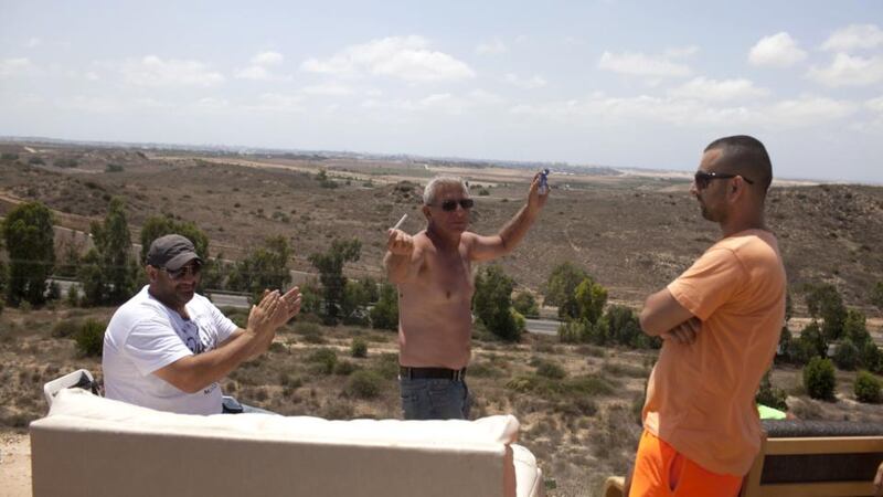 Israelis pictured on a hill overlooking the Gaza Strip  near Sderot, Israel. Locals have been gathering on the site to watch Israel’s artillery bombardment of the  Gaza Strip. Photograph:  Lior Mizrahi/Getty Images