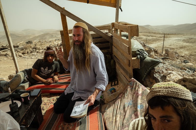 Israeli settlers hold a Torah lesson at an illegal outpost set up by settlers near Tekoa, a settlement in the occupied West Bank. Photograph: Tamir Kalifa/The New York Times
                      