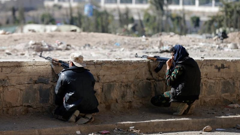 Houthi fighters take up position on a street during clashes near the Presidential Palace in Sanaa. Photograph: Khaled Abdullah/Reuters