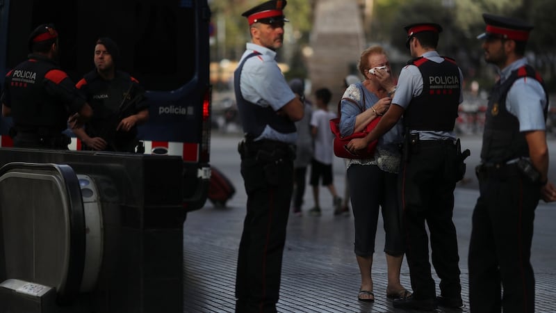 Pilar Revilla, 75, gets emotional after hugging a Catalan Mossos d’Esquadra officer after visiting an impromptu memorial where a van crashed into pedestrians at Las Ramblas in Barcelona, Spain, August 20, 2017. Photograph: REUTERS/Susana Vera