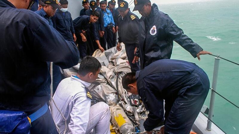 A  handout photograph released by the Royal Malaysian Navy  shows officials retrieving the emergency evacuation tube from AirAsia flight QZ8501 during the search and rescue mission in the ocean off the coast of Pangkalan Bun, Borneo, Indonesia. Photograph: Malaysian Navy/EPA.