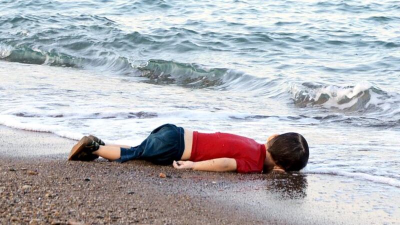 A young refugee, who drowned in a failed attempt to sail to the Greek island of Kos, lies on the shore in the coastal town of Bodrum, Turkey. Photograph: Nilufer Demir/DHA/Reuters