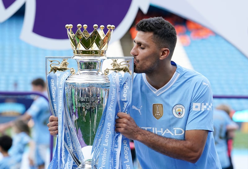 Manchester City's Rodri kissing the Premier League trophy. Photograph: Martin Rickett/PA