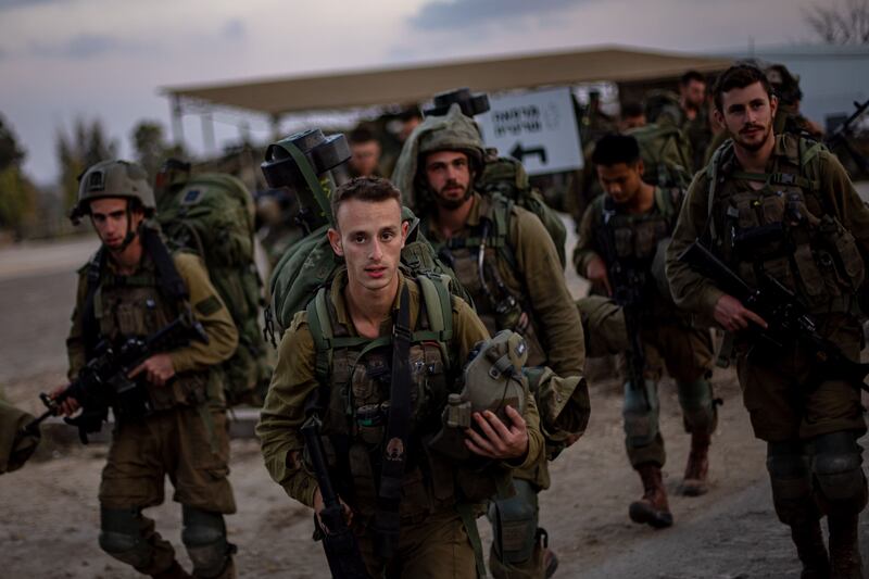 Israeli soldiers stand on a road near Be'eri. On Wednesday, the entire Gaza periphery was full of troops preparing for the ground offensive. Photograph: Miarin Divisek/EPA