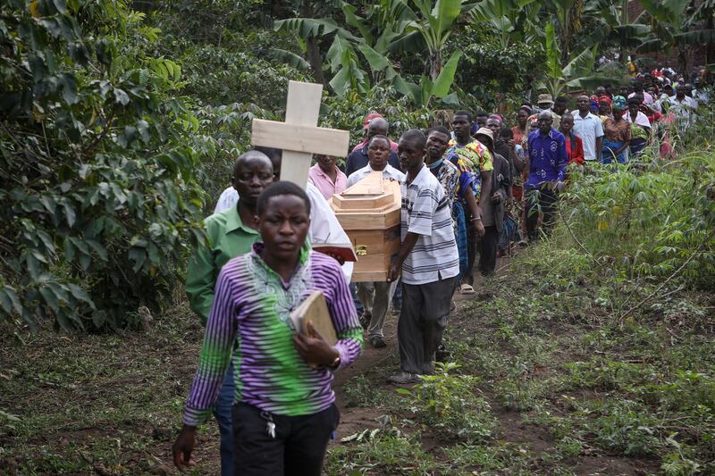 The coffins of victims are taken to be buried. Photograph: Hajarah Nalwadda/AP