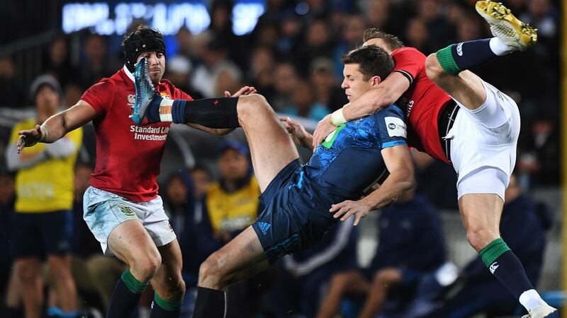 Blues’ Matt Duffie is tackled by Liam Williams. Photo: Andrew Cornaga/Inpho