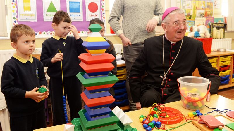 January 21st 2016: Archbishop Diarmuid Martin with Karol Hawriluk and Sean Moore, junior infants at Our Lady of the Wayside National School in Bluebell, Dublin. Photograph: Eric Luke/The Irish Times