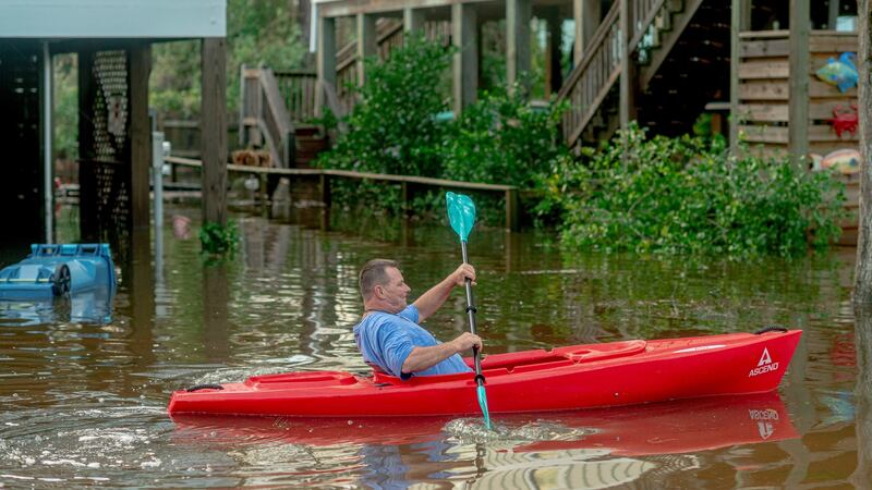 Steve Cabon kayaks around the Bear Point neighbourhood where he lives in Orange Beach, Alabama after Hurricane Sally on Wednesday. Photograph: Emily Kask/The New York Times