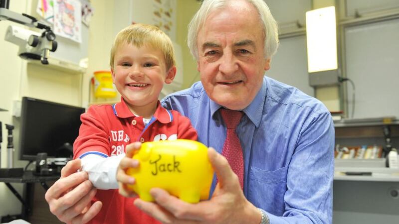 Prof Michael O’Keeffe, consultant opthalmologist at Temple Street hospital, with Jack Teeling (6) who lost an eye after he had tumours behind it. Photograph: Ciara Wilkinson