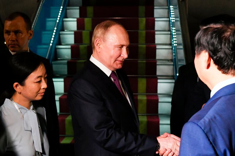 Russian president Vladimir Putin shakes hands with Vietnamese officials on arrival in Vietnam. Photograph: AP