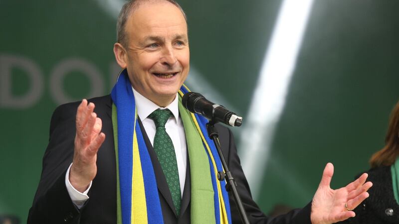 Taoiseach Micheál Martin wears two scarves – one green, one blue and yellow – on stage in Trafalgar Square in London on Sunday. Photograph: James Manning/PA