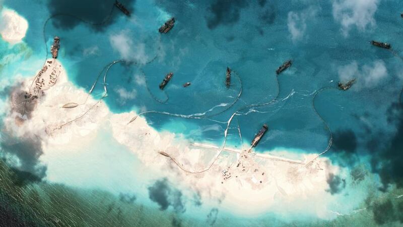 A satellite image shows Chinese dredgers at  Mischief Reef, part of the Spratly Islands, in the South China Sea, last Month. There is evidence that China is aggressively building artificial reef in the area. Photograph: Asia Maritime Transparency Initiative/New York Times