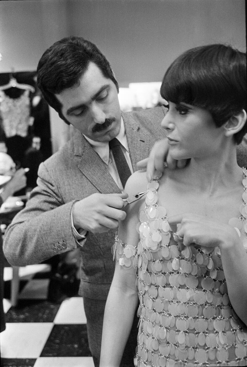 Paco Rabanne uses pliers to repair one of his plastic and metal dresses during a show at Lord & Taylor in New York, March 28th, 1966. Photograph: Neal Boenzi/The New York Times