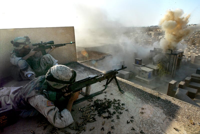 American soldiers fighting in Najaf, Iraq on August 11th, 2004. Two decades after the Bush administration said it wanted to disarm weapons of mass destruction and free Iraqis, the debates continues about the decision. Photograph: Tyler Hicks/New York Times
                      