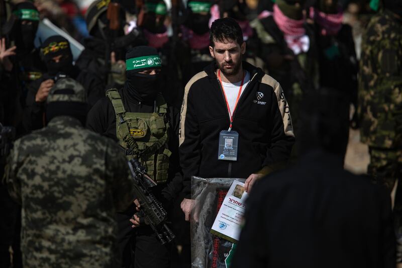 Hamas and Islamic Jihad militants escort US-Israeli hostage Sagi Dekel Chen before handing him over to the Red Cross team, in Khan Yunis, in the southern Gaza Strip, on Saturday. Photograph: Haitham Imad/EPA