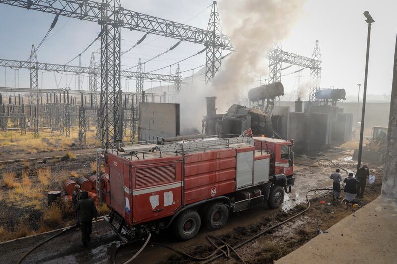 Firefighters work at the scene of an Israeli air strike on a power station in Sanaa, Yemen. Photograph: Osamah Abdulrahman/AP