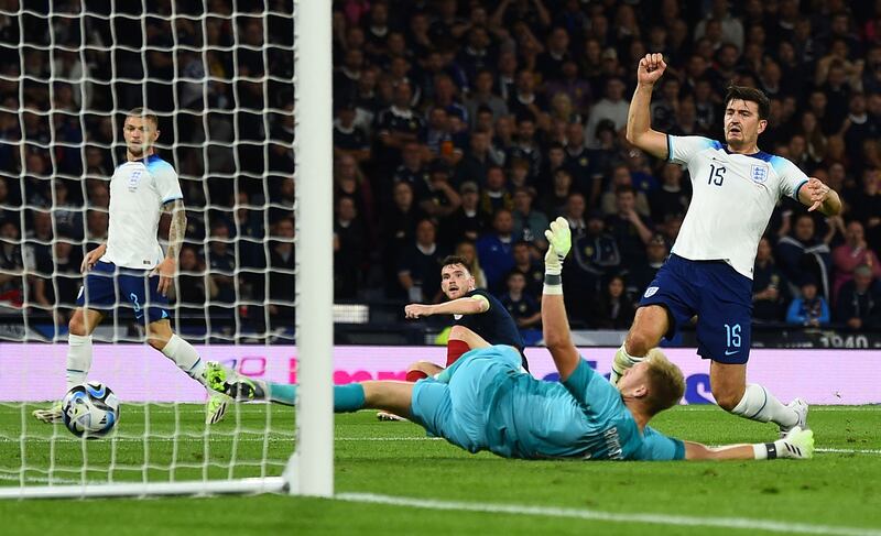 Scotland's defender Andrew Robertson celebrates as England's Harry Maguire scores an own goal during the international friendly at Hampden Park. Photograph: Andy Buchanan/AFP via Getty Images