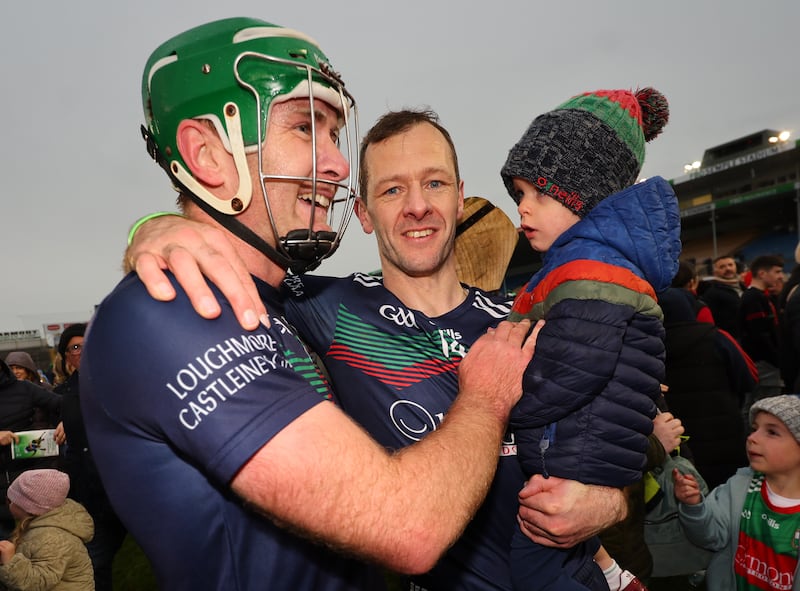 Noel McGrath celebrates winning the hurling county final with Ciaran McGrath and his son Billy. Photograph: James Crombie/Inpho