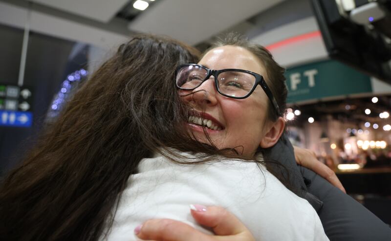 Caroline Beahan (facing camera) is hugged by her sister Elizabeth  on her return home from Vancouver for Christmas. Photo: Bryan O’Brien / The Irish Times

