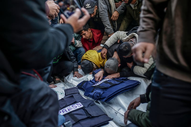 People mourn over the covered bodies of Palestinian journalists killed in the Israeli air strike. Photograph: Mohammed Saber/EPA