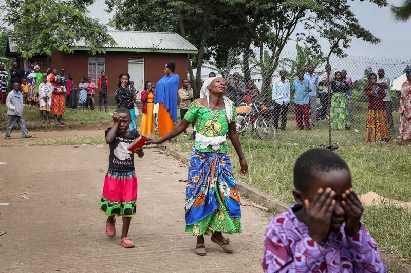 Relatives wait to collect the bodies of victims of the attack. Photograph: Hajarah Nalwadda/AP