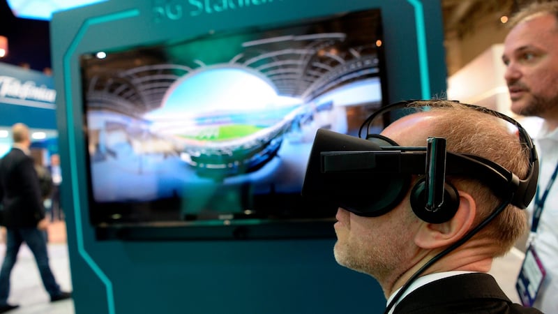 A visitor tests a virtual reality headset at the Telefonica stand at the Mobile World Congress. Photograph: Josep Lago/AFP